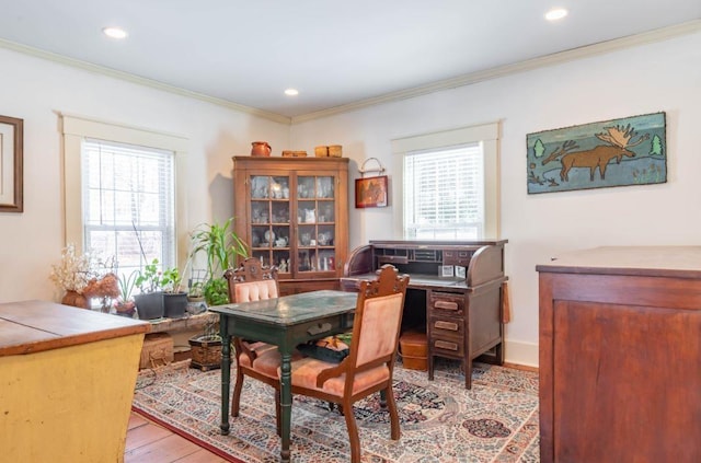 office space featuring light hardwood / wood-style floors, crown molding, and a healthy amount of sunlight