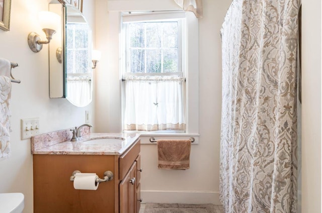 bathroom with toilet and vanity