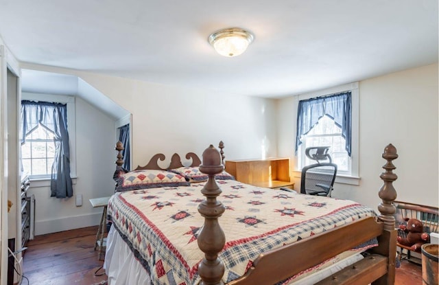 bedroom with dark hardwood / wood-style flooring