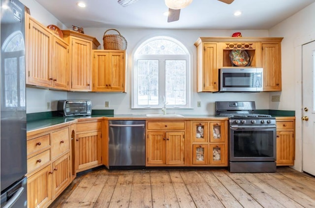 kitchen featuring light hardwood / wood-style floors, sink, a wealth of natural light, and stainless steel appliances