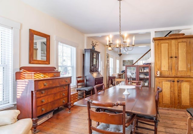 dining room with a chandelier and light wood-type flooring