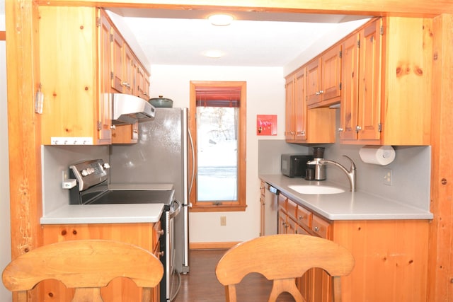 kitchen with decorative backsplash, appliances with stainless steel finishes, and sink