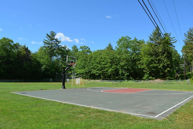 view of basketball court with a yard