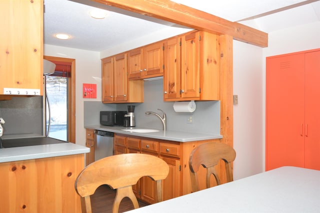 kitchen with decorative backsplash, dishwasher, and sink