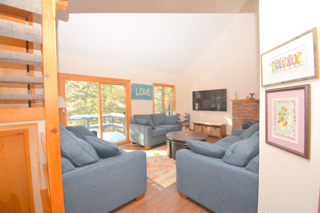 living room with hardwood / wood-style flooring and high vaulted ceiling