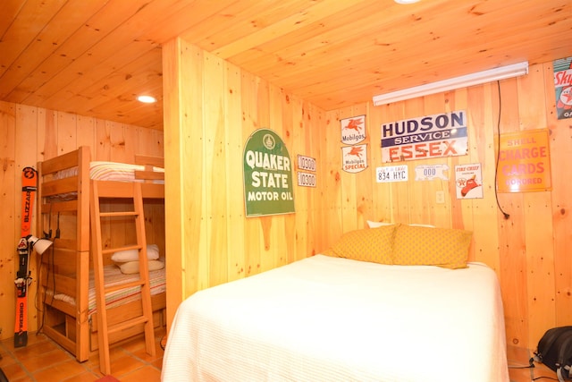 bedroom featuring wooden ceiling, wood walls, and tile patterned flooring