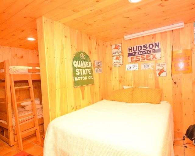 bedroom featuring wooden ceiling, tile patterned flooring, and wood walls