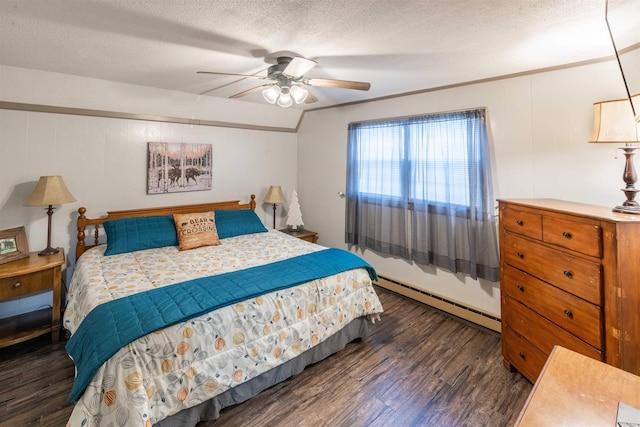 bedroom with a baseboard heating unit, ceiling fan, vaulted ceiling, dark wood-type flooring, and a textured ceiling