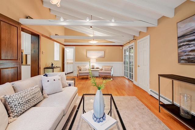 living room with light hardwood / wood-style flooring and vaulted ceiling with beams