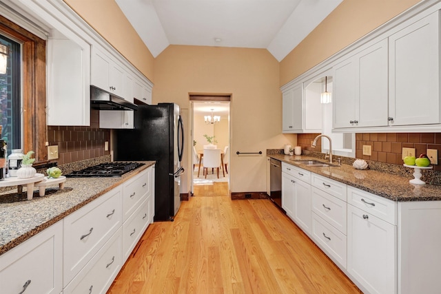 kitchen featuring sink, vaulted ceiling, dishwasher, and white cabinets