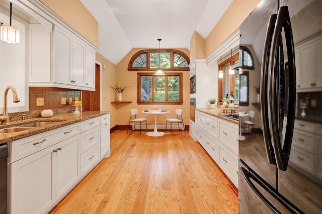 kitchen with lofted ceiling, pendant lighting, black appliances, and white cabinets