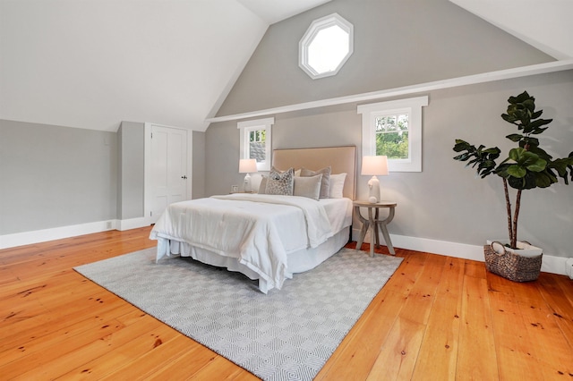 bedroom with lofted ceiling and hardwood / wood-style floors