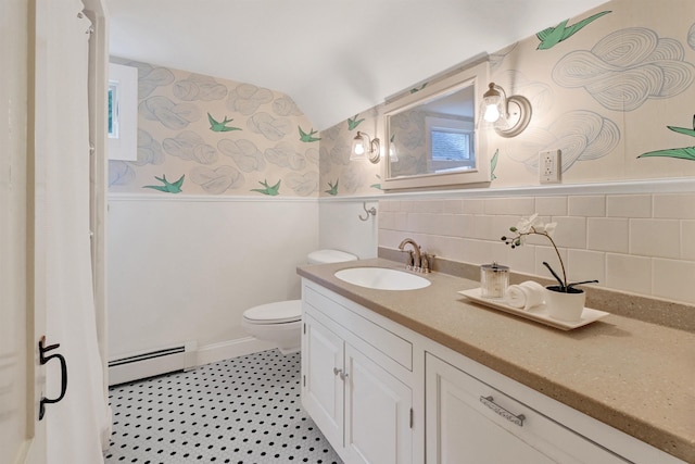 bathroom with vanity, a baseboard heating unit, and toilet