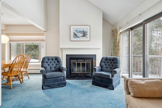 living area featuring plenty of natural light, vaulted ceiling, and carpet flooring