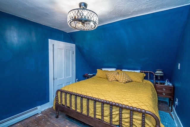 bedroom featuring a baseboard heating unit, a textured ceiling, a chandelier, and lofted ceiling