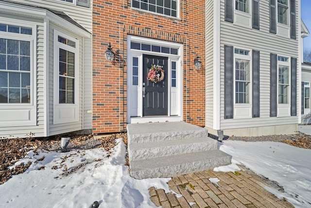 view of snow covered property entrance