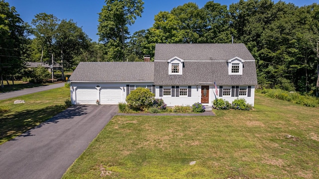 new england style home with a garage and a front yard