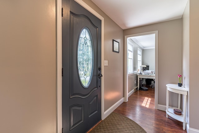 foyer entrance featuring dark wood-type flooring and ornamental molding