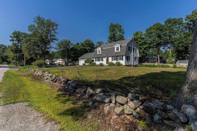 view of property exterior featuring a lawn