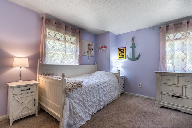 carpeted bedroom featuring a textured ceiling