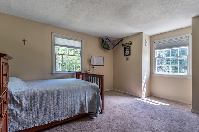 carpeted bedroom with a textured ceiling