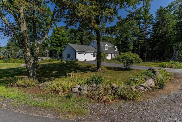 exterior space featuring a lawn and a garage