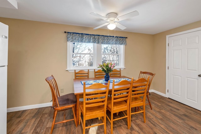 dining space with ceiling fan and dark hardwood / wood-style flooring