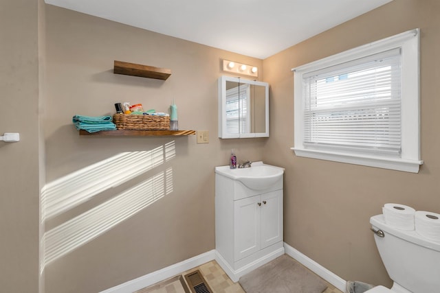 bathroom with toilet and vanity