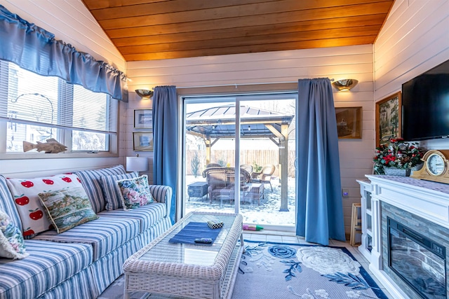 living room featuring wooden ceiling, lofted ceiling, and wood walls