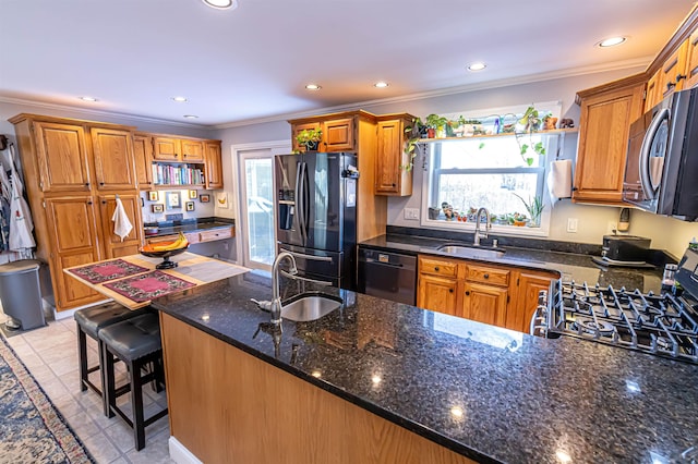 kitchen featuring black appliances, a kitchen bar, sink, and crown molding