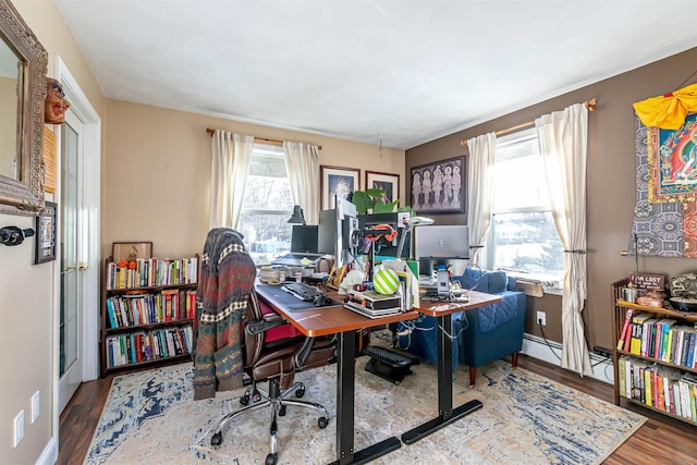 office area with baseboard heating and hardwood / wood-style floors