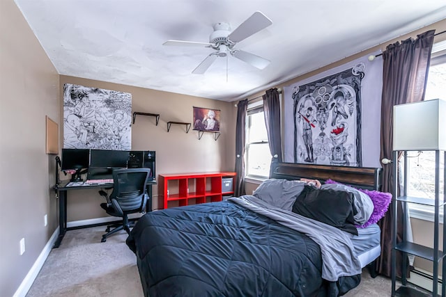 bedroom featuring ceiling fan, baseboard heating, and light carpet