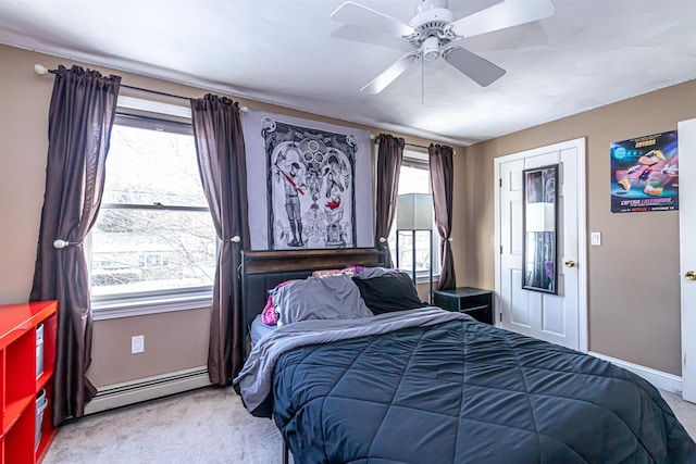 carpeted bedroom featuring ceiling fan, a closet, and a baseboard radiator