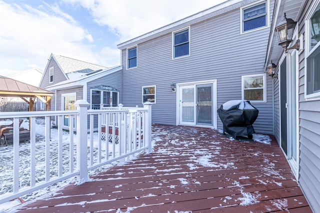 snow covered deck featuring a gazebo and a grill