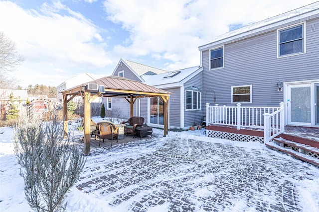 snow covered deck featuring a gazebo