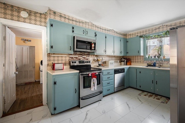 kitchen featuring stainless steel appliances, tasteful backsplash, and sink