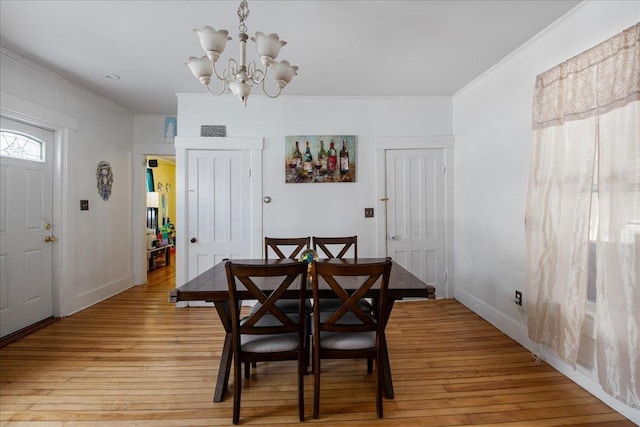 dining area featuring an inviting chandelier and light hardwood / wood-style flooring