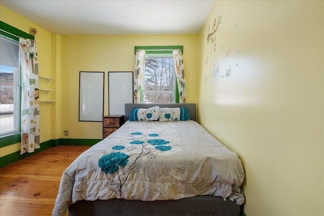 bedroom with wood-type flooring