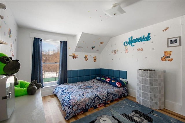 bedroom featuring vaulted ceiling and hardwood / wood-style floors