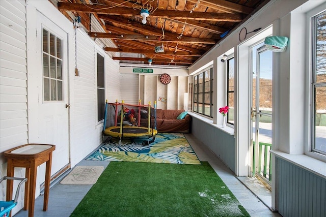 sunroom / solarium with radiator, lofted ceiling with beams, and wooden ceiling