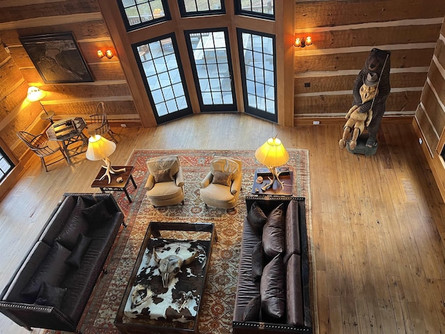 unfurnished living room featuring wooden walls