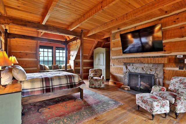 bedroom with hardwood / wood-style floors, wooden walls, a fireplace, wooden ceiling, and beam ceiling