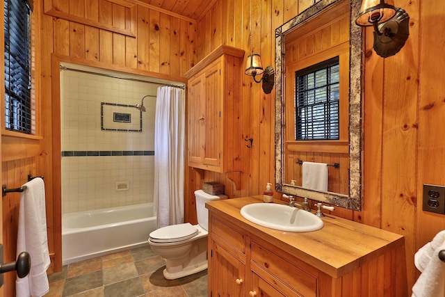 full bathroom with shower / bath combo with shower curtain, toilet, vanity, and wood walls