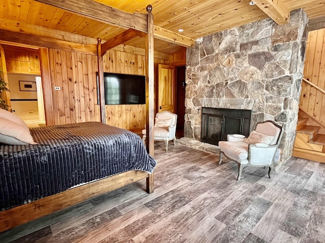 bedroom featuring beam ceiling, wood ceiling, and wood walls