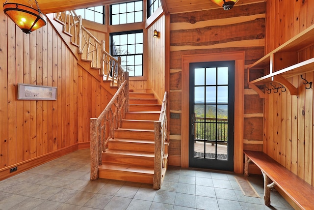 interior space featuring tile patterned flooring and wooden walls