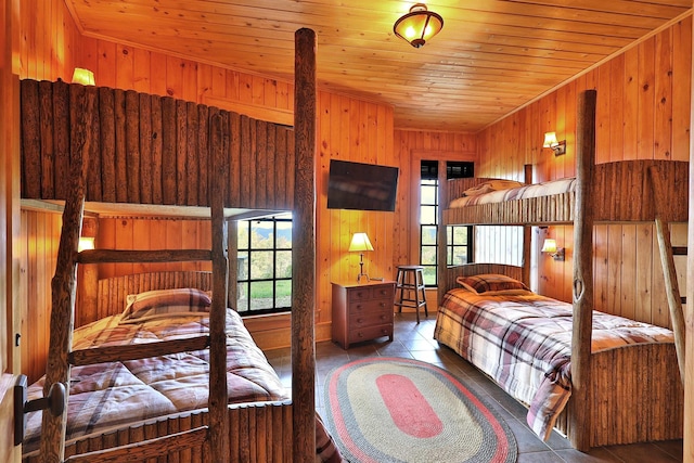 tiled bedroom with wood ceiling and wood walls