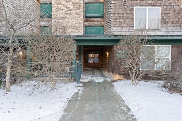 view of snow covered property entrance