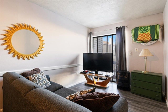 living room featuring dark hardwood / wood-style flooring and a textured ceiling