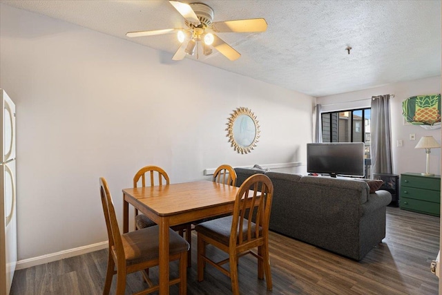 dining area featuring ceiling fan, a textured ceiling, and dark hardwood / wood-style flooring