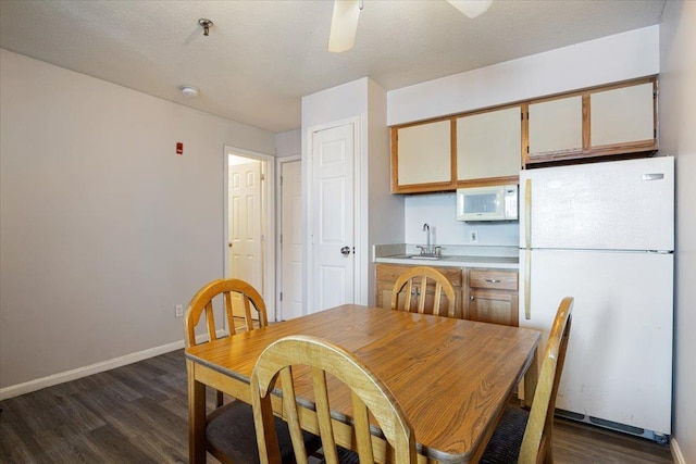 dining space with dark hardwood / wood-style flooring and sink